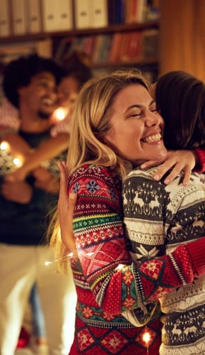 Family gathering and hugging by a Christmas tree in a warm living room