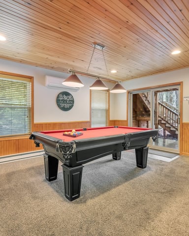 Recreation room with pool table, arcade game, wood ceiling, and wood-paneled walls